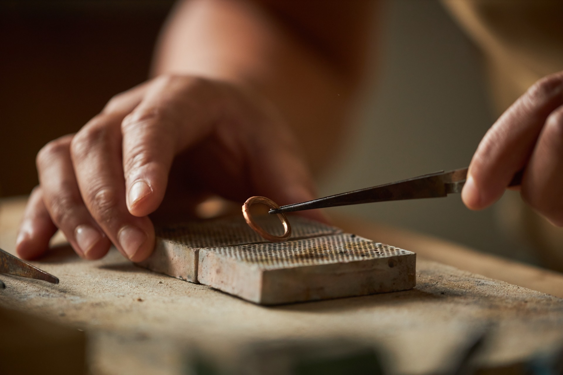 Maestro trabajando en la creación de un anillo artesanal durante un taller